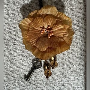 Gold flower necklace with antique key.